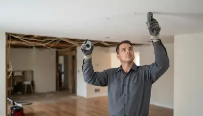 Electrician uses a stud finder and chalk line to mark recessed lighting in a Peoria, IL ceiling