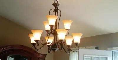 Classic ceiling chandelier installation with warm lighting in Peoria, IL