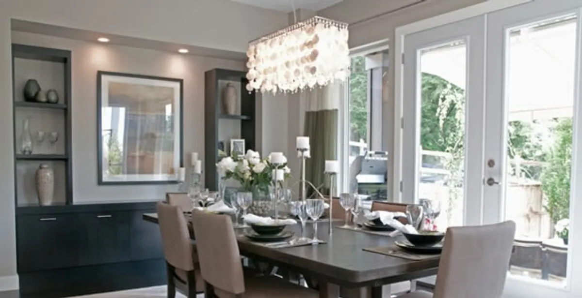 Elegant dining room chandelier installation above table in Peoria, IL