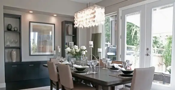 Elegant dining room chandelier installation above table in Peoria, IL
