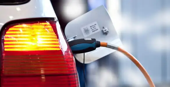 Electric car plugged into EV charger after professional installation in Peoria, IL