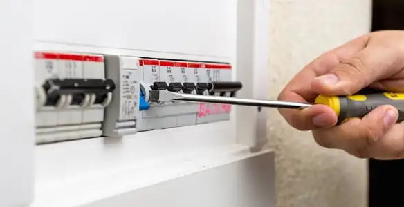 electrical panel upgrade service showing technician adjusting circuit breakers during system upgrade in Peoria, IL