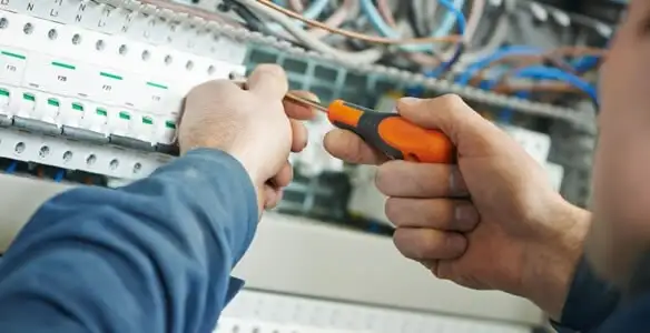 electrical service showing licensed electrician performing electrical panel maintenance and adjustments in Peoria, IL