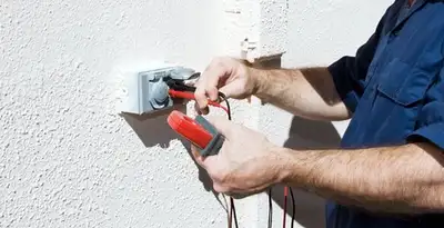 Electrician performing home electrical outlet and wiring inspection in Peoria, IL
