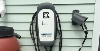 Outdoor electric vehicle charger installation on residential wall in Peoria, IL