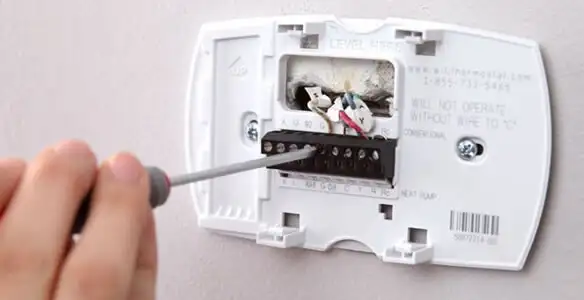 Thermostat installation service with proper wiring and secure wall mounting in Peoria, IL