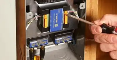 Whole home surge protection device being installed by a licensed electrician to protect electrical systems in Peoria, IL